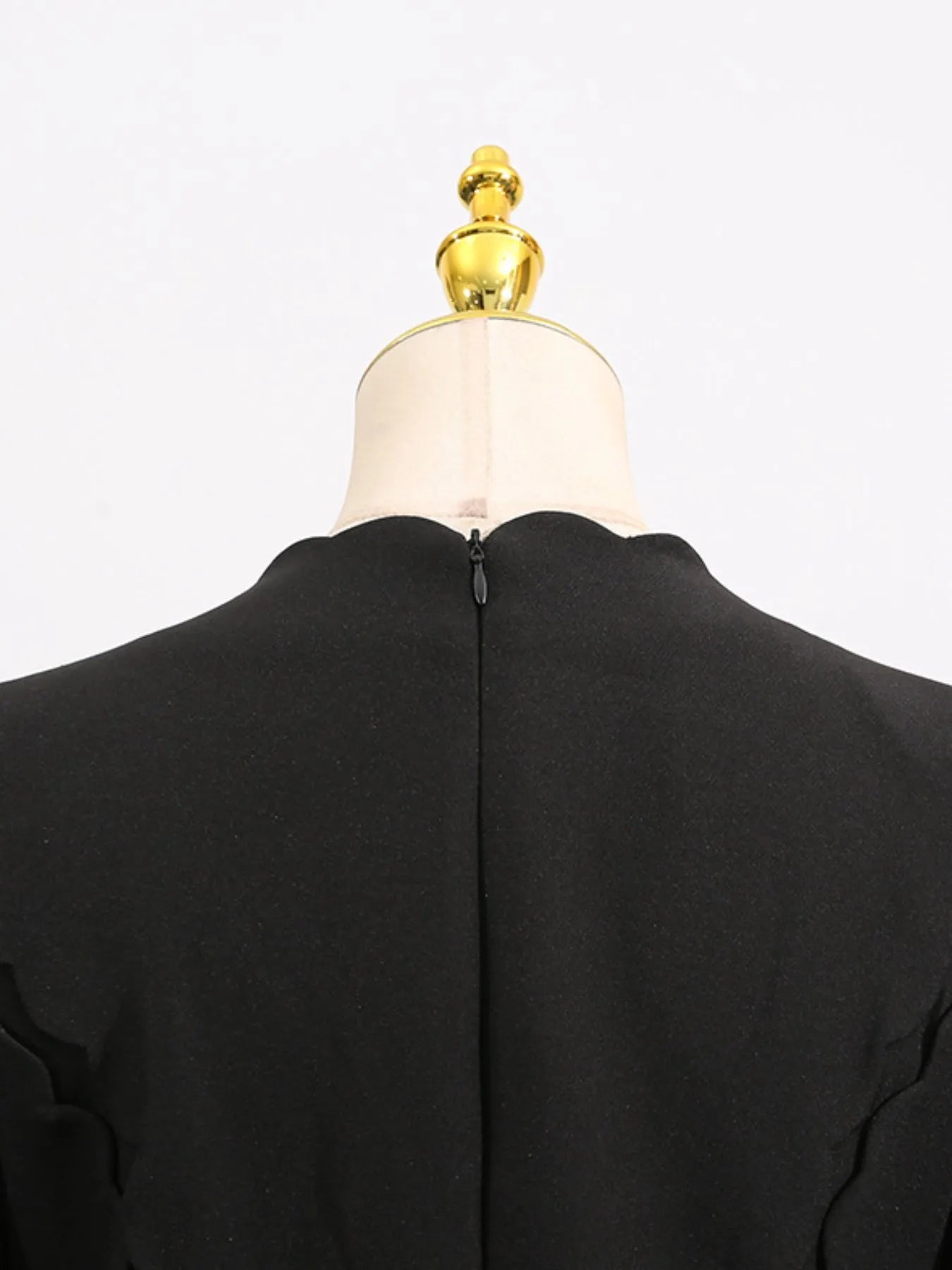 long sleeve bow front midi dress shown from back on mannequin with center back zipper and scalloped neckline