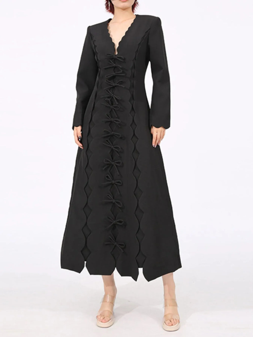 black long sleeve bow front midi dress with scalloped V neck central bow row and A line silhouette