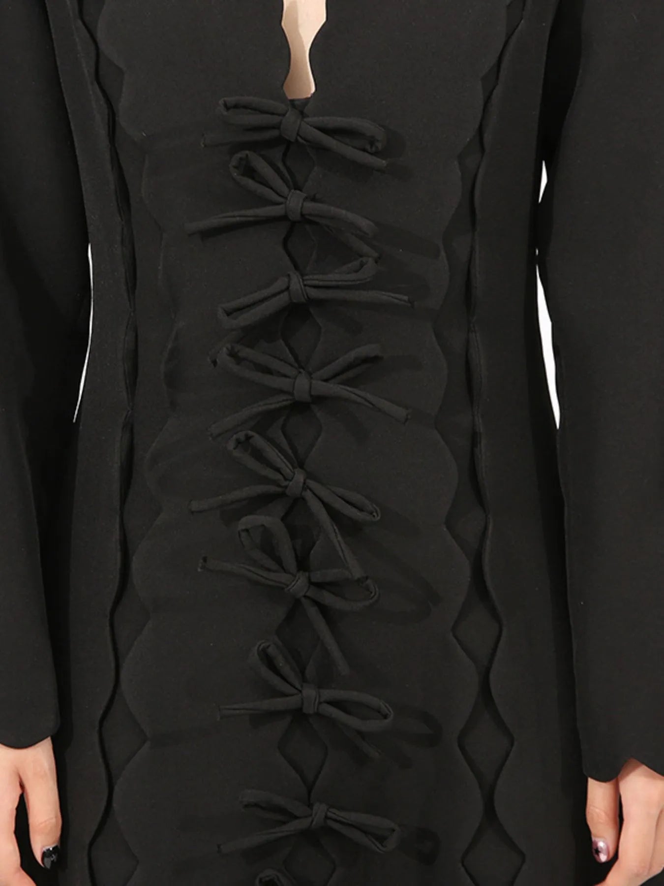 black long sleeve bow front midi dress close up showing multiple front bows and scalloped trim