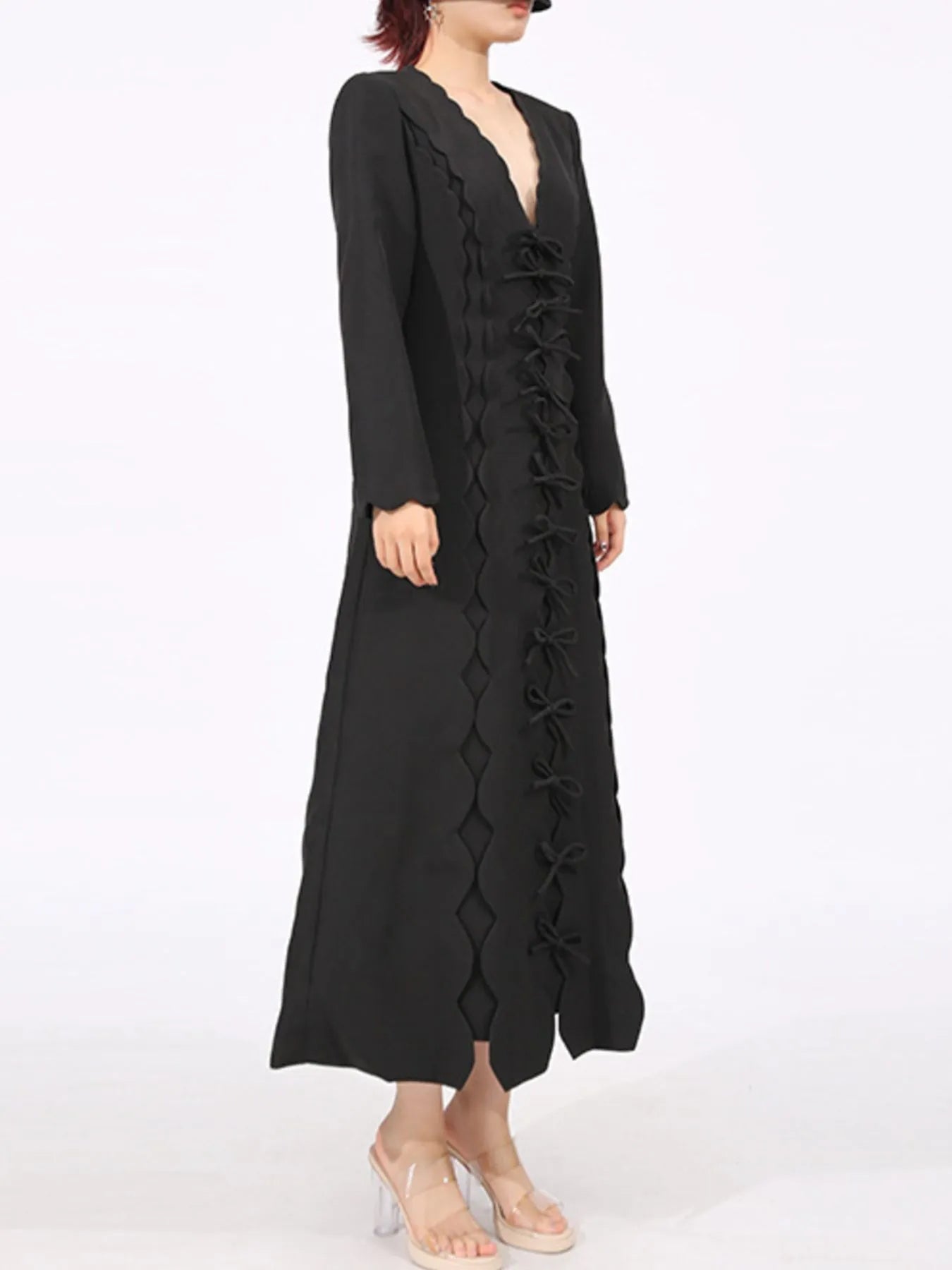 black long sleeve bow front midi dress with scalloped edges deep V neckline on model