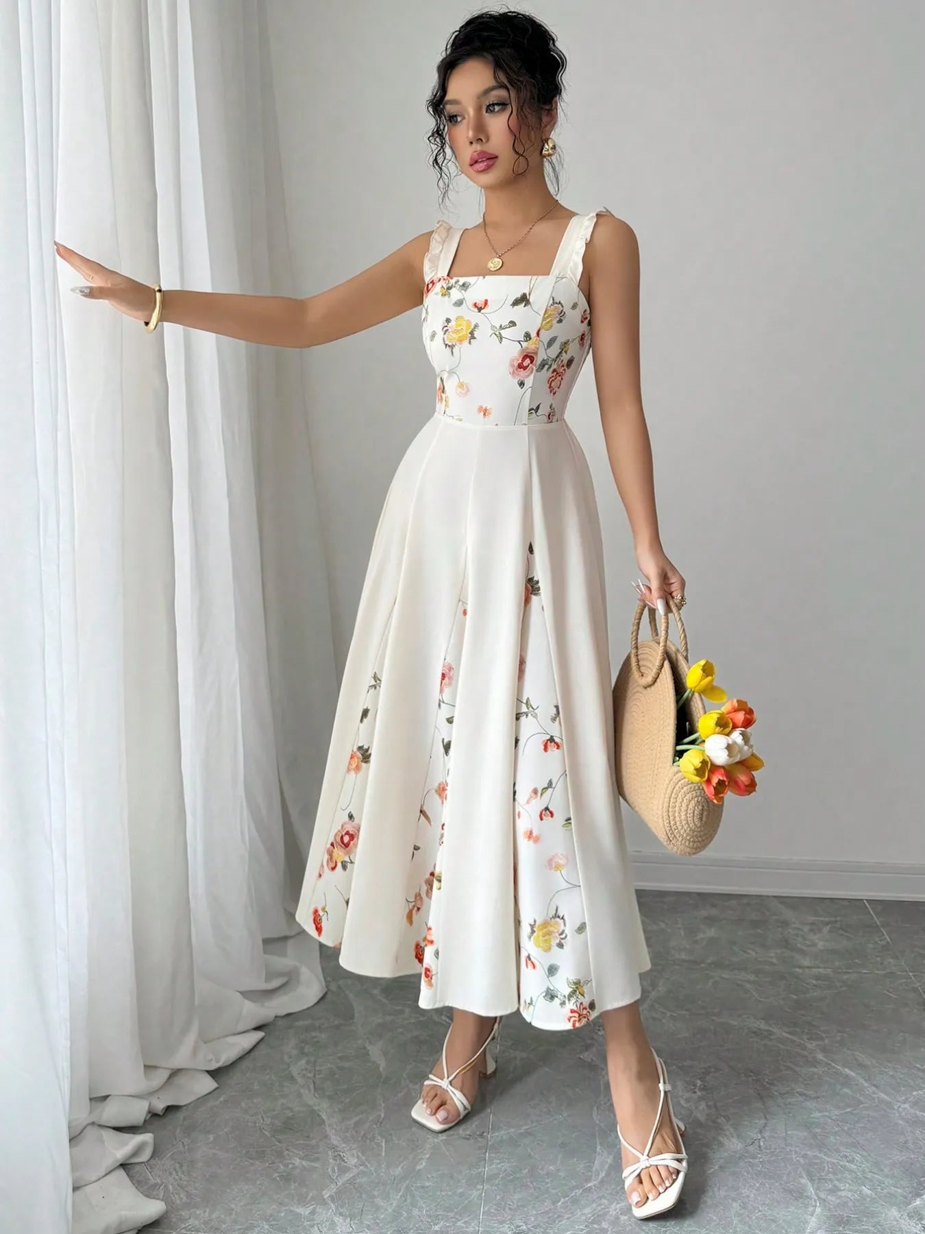 model wearing a white floral printed square neck midi dress with flared skirt and straw bag