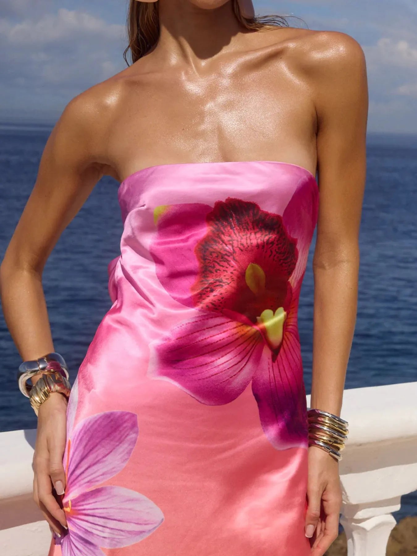 printed tube maxi dress strapless pink floral silk look gown worn on model by ocean