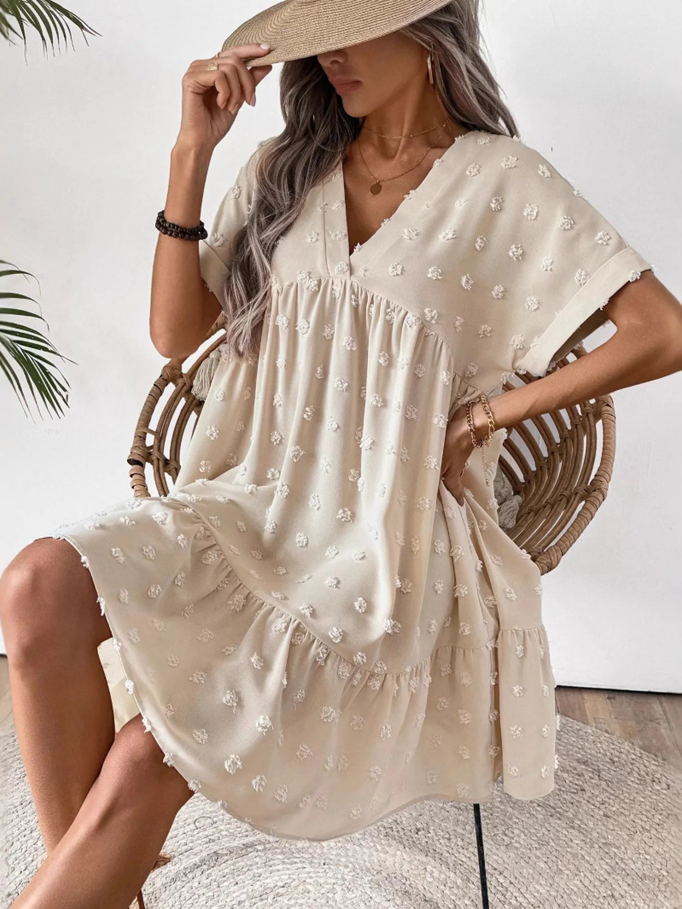 ruffled hem swiss dot mini dress cream V neck short sleeve loose fit model wearing straw hat