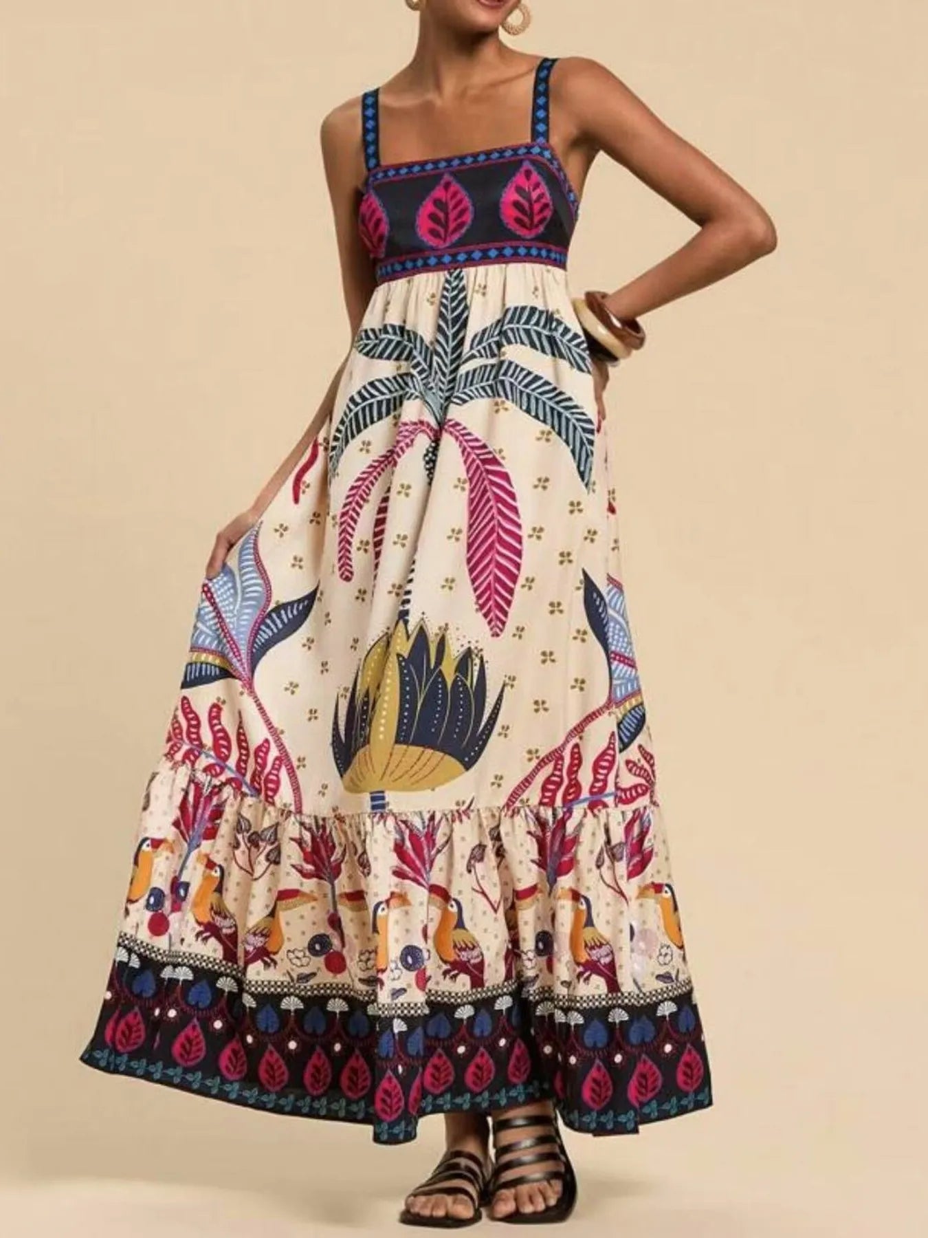 tropical print maxi dress with square neckline thin straps empire waist tiered hem and colorful botanical pattern