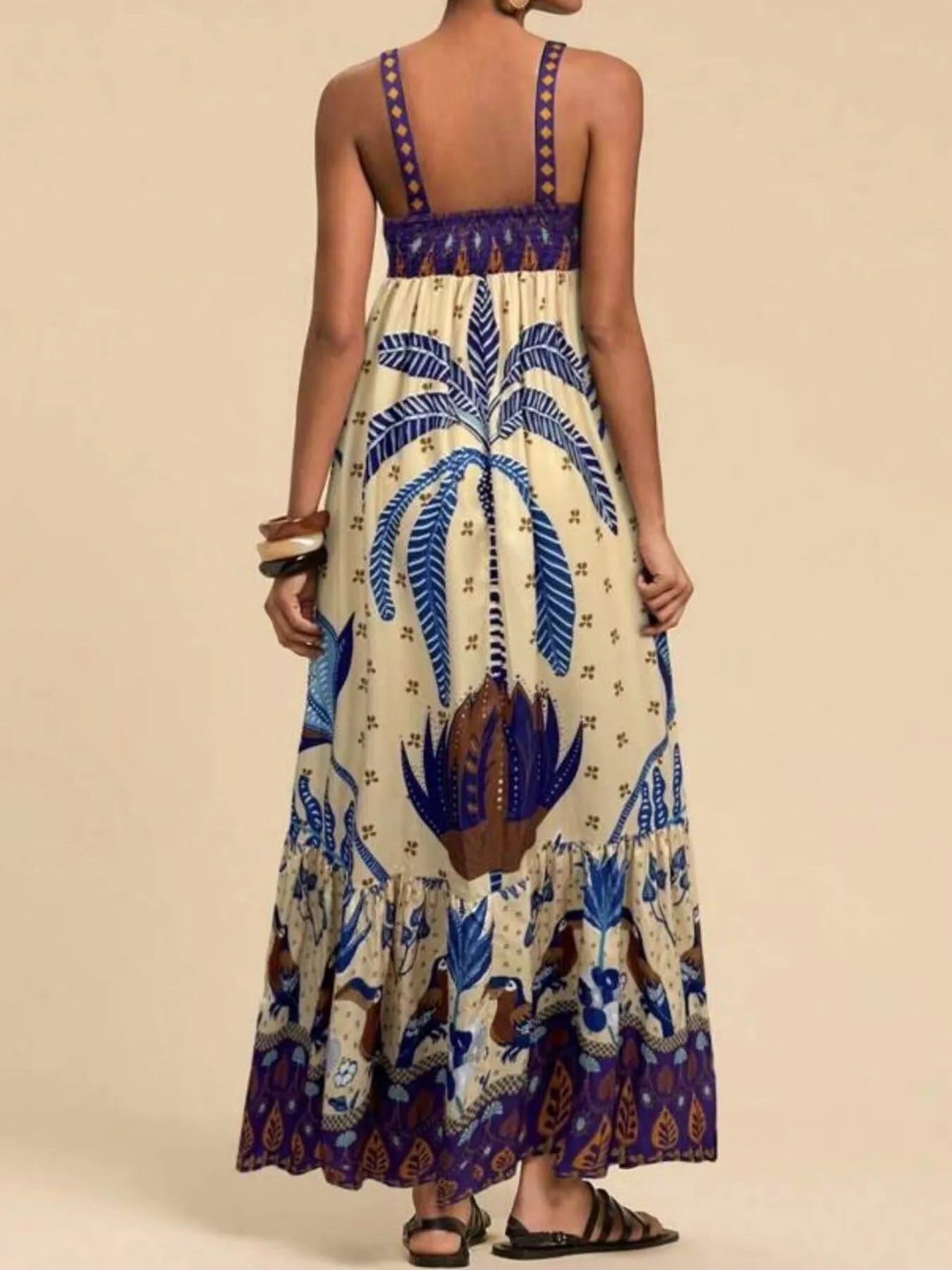 tropical print maxi dress back view with blue palm motif purple smocked bodice and ruffle hem