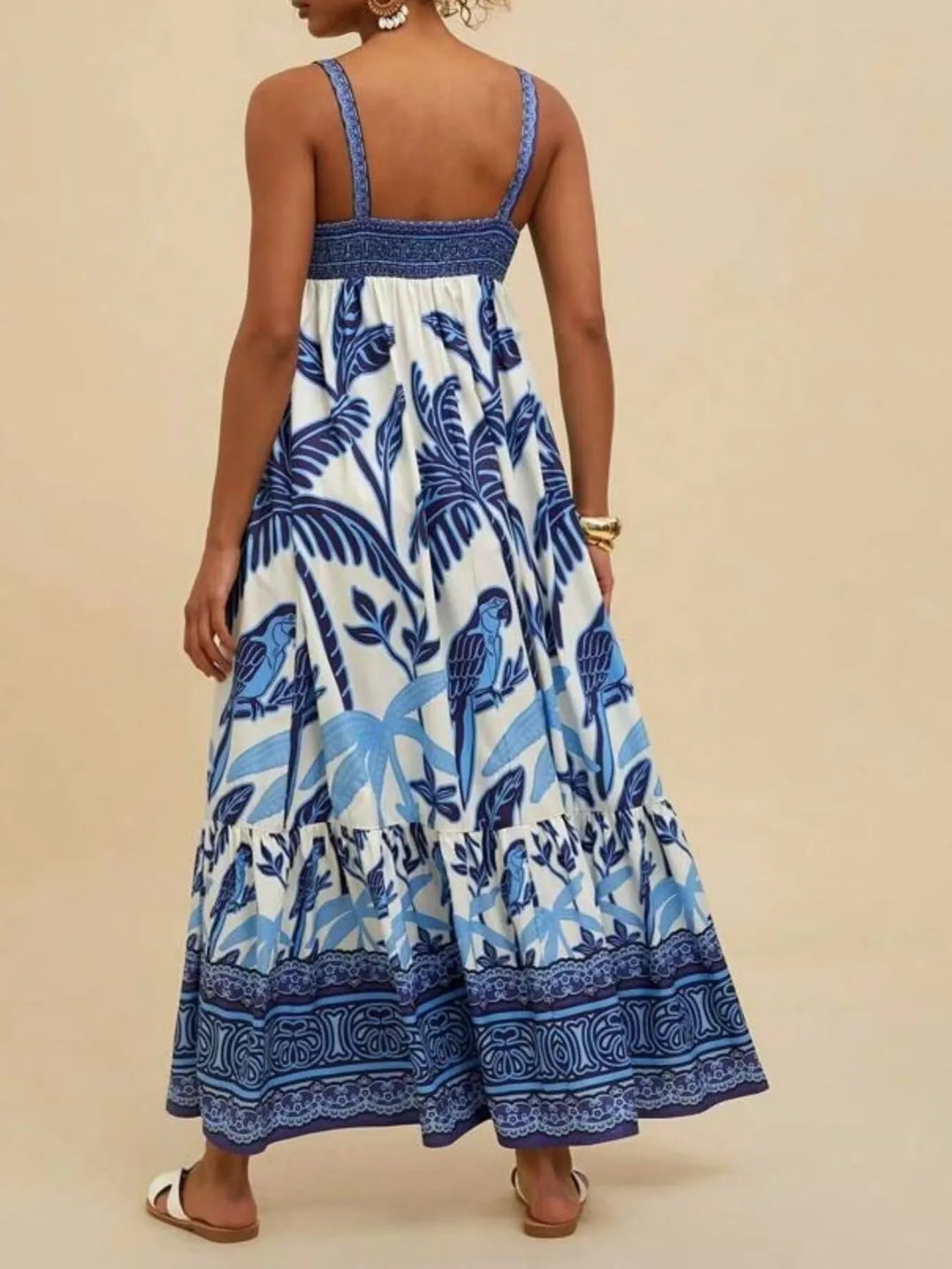 tropical print maxi dress back view in blue white with smocked bodice braided straps and tiered ankle length skirt