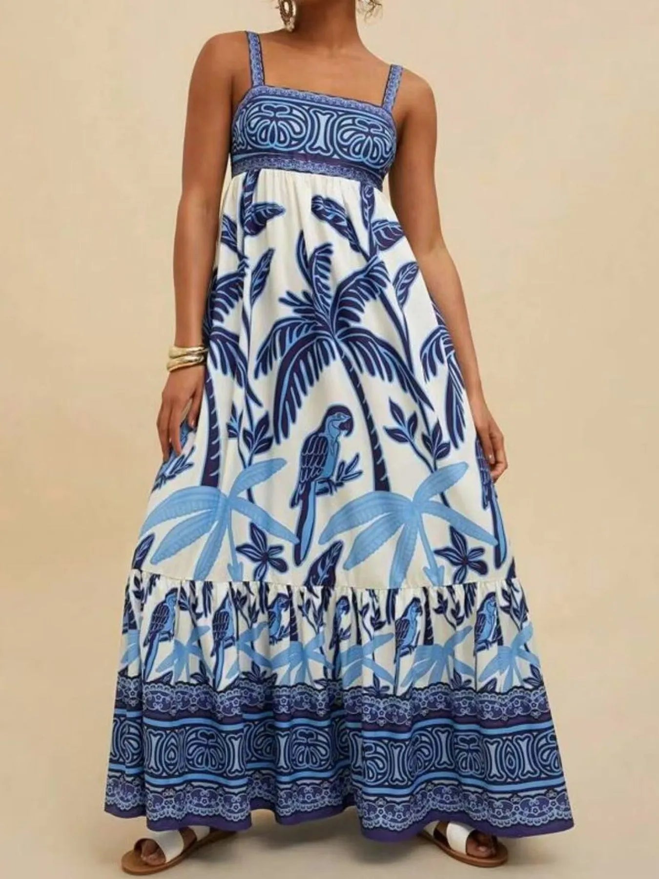blue and white tropical print maxi dress with palm trees and parrot motif square neckline and tiered hem