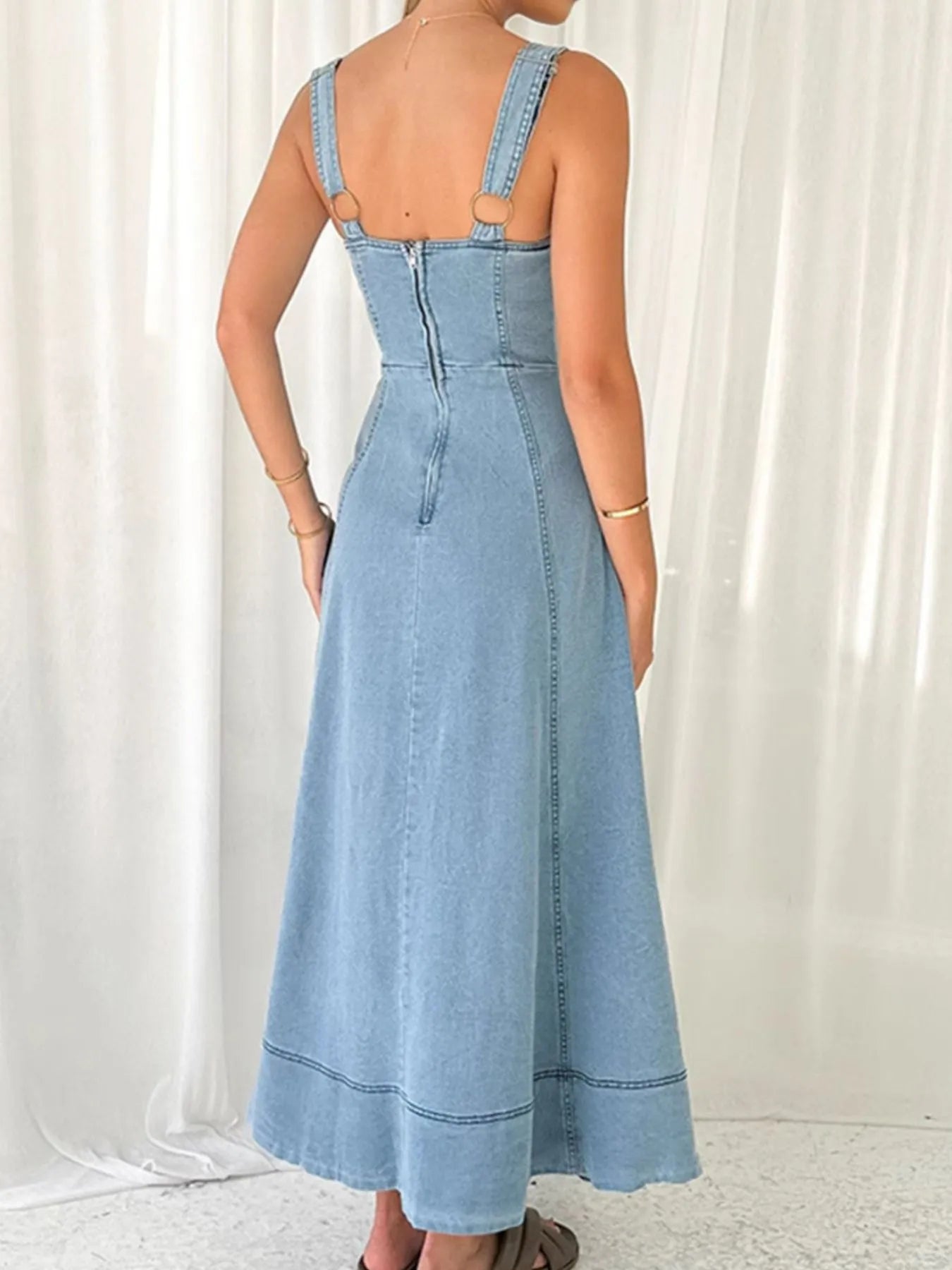 Trendsi light wash wide strap denim dress back view with center zipper ring hardware straps and A line skirt