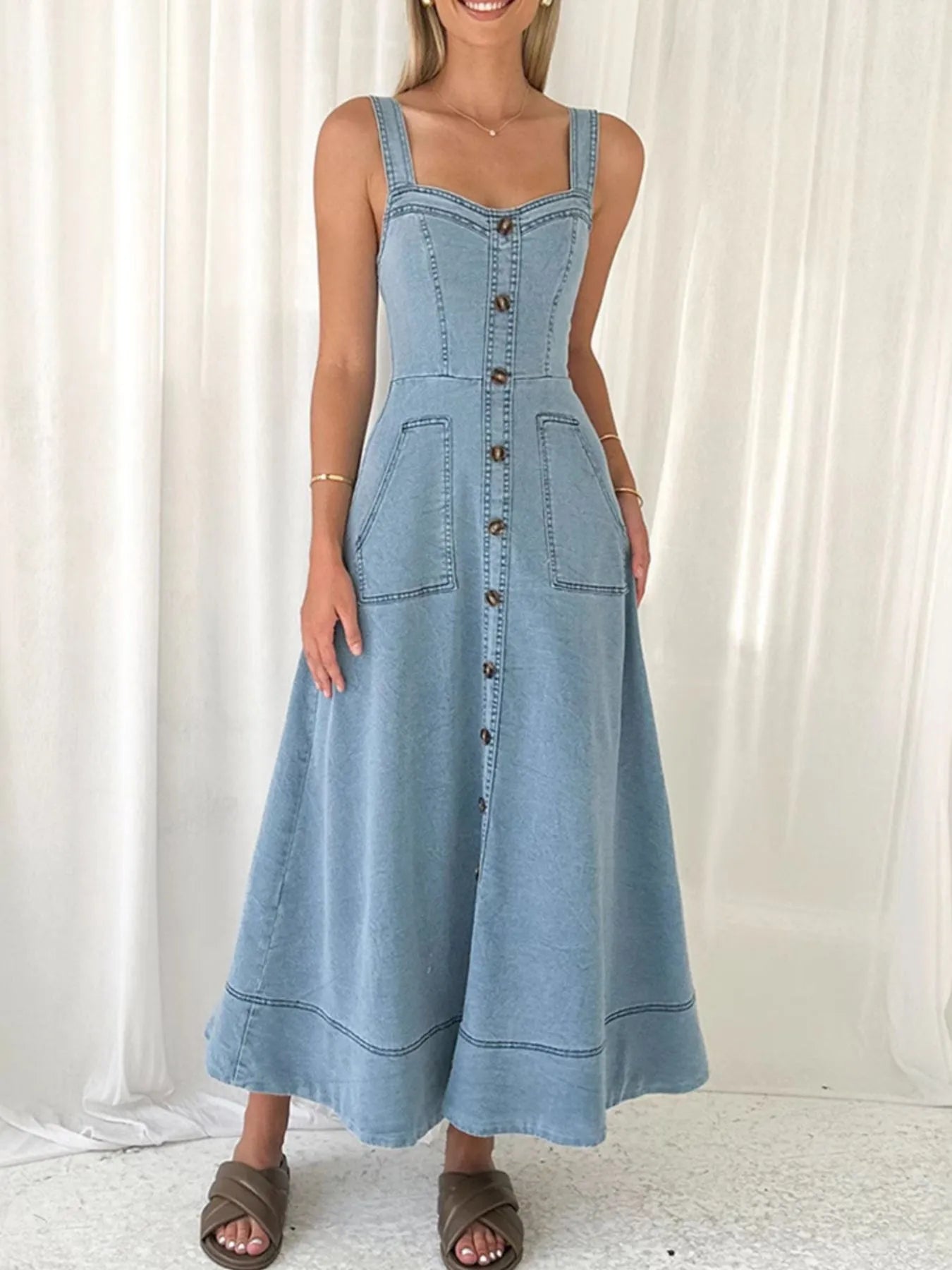 light wash wide strap denim dress with button front patch pockets and a line midi skirt