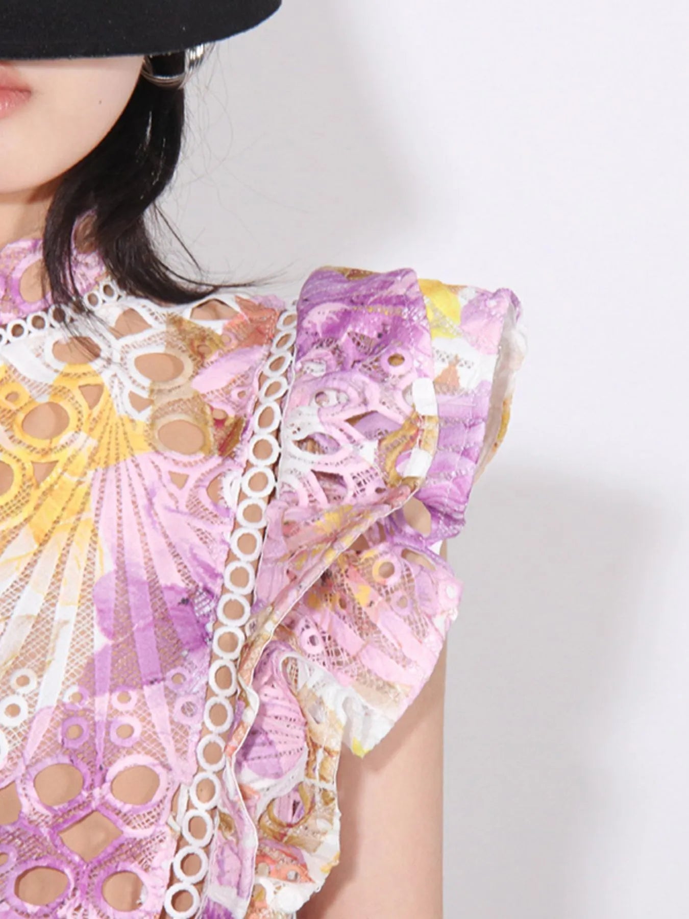 ruffled hollow out midi dress close up showing pink purple yellow lace sunburst pattern and ruffled sleeve