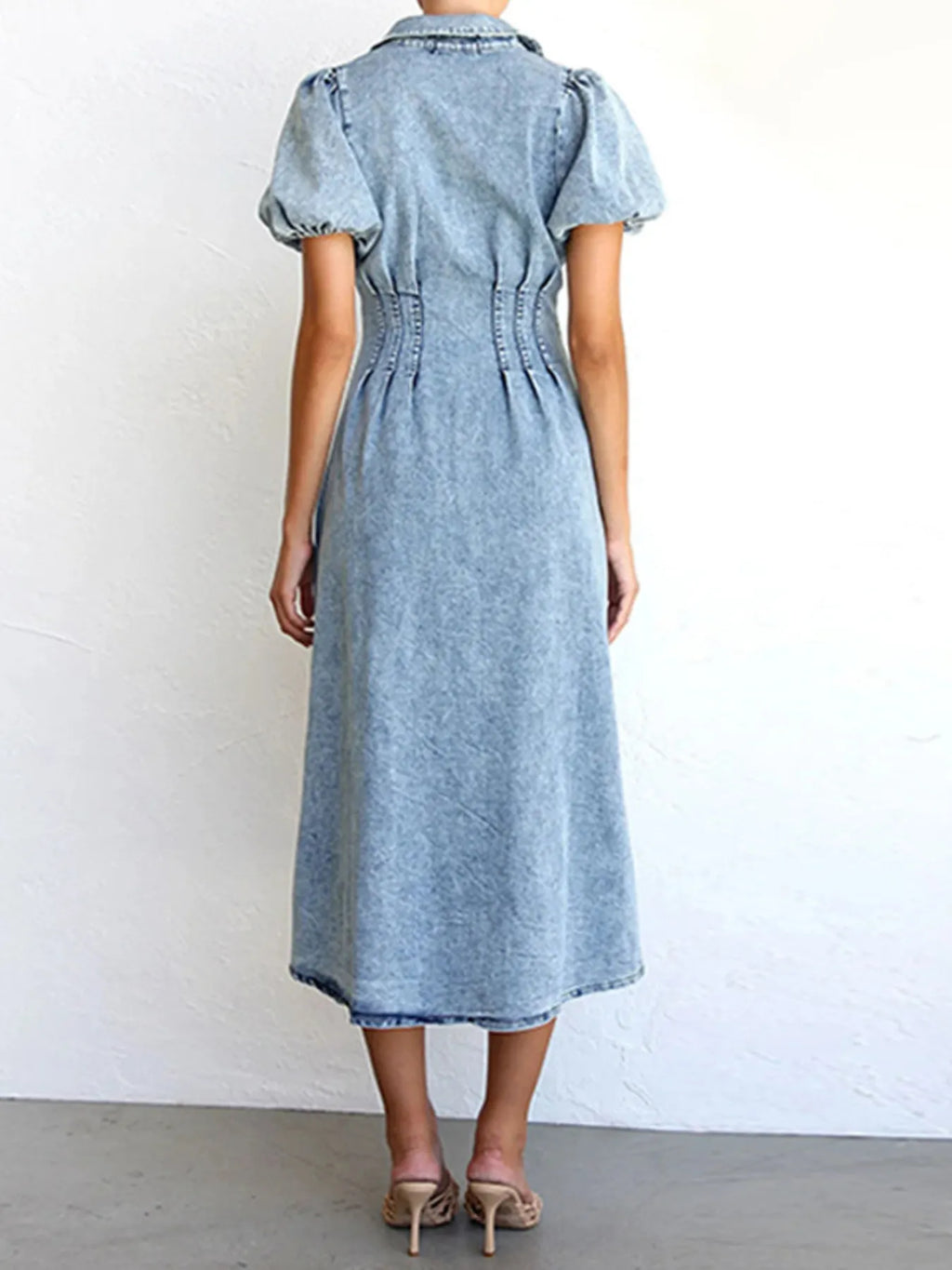 Back view light wash puff sleeve denim midi dress with gathered waist collar and midi length
