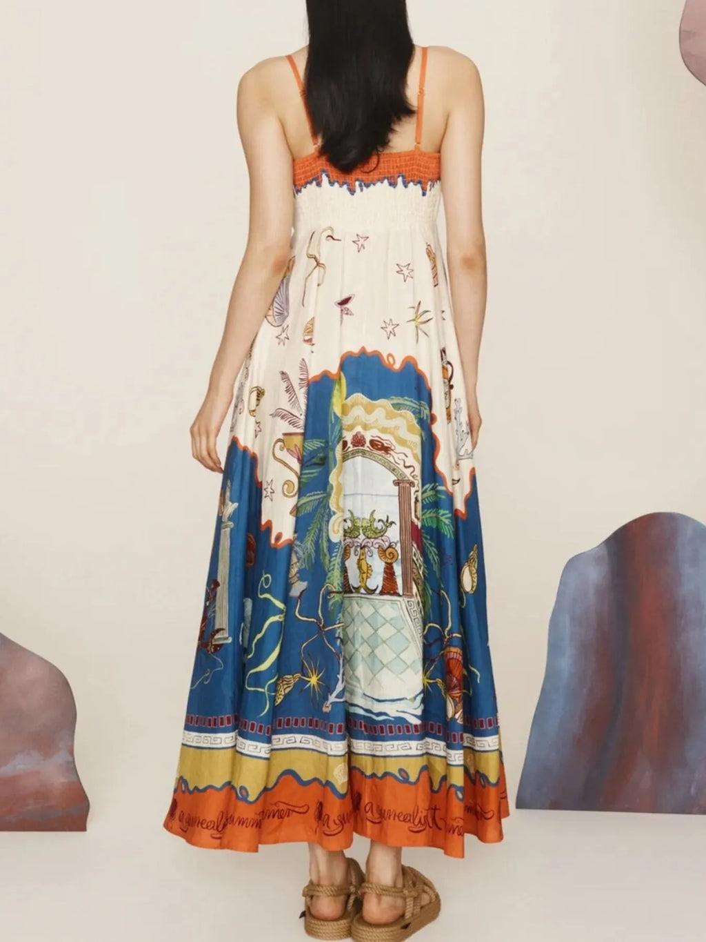 printed square neck maxi dress back view with orange smocked straps colorful boho print and flowy hem