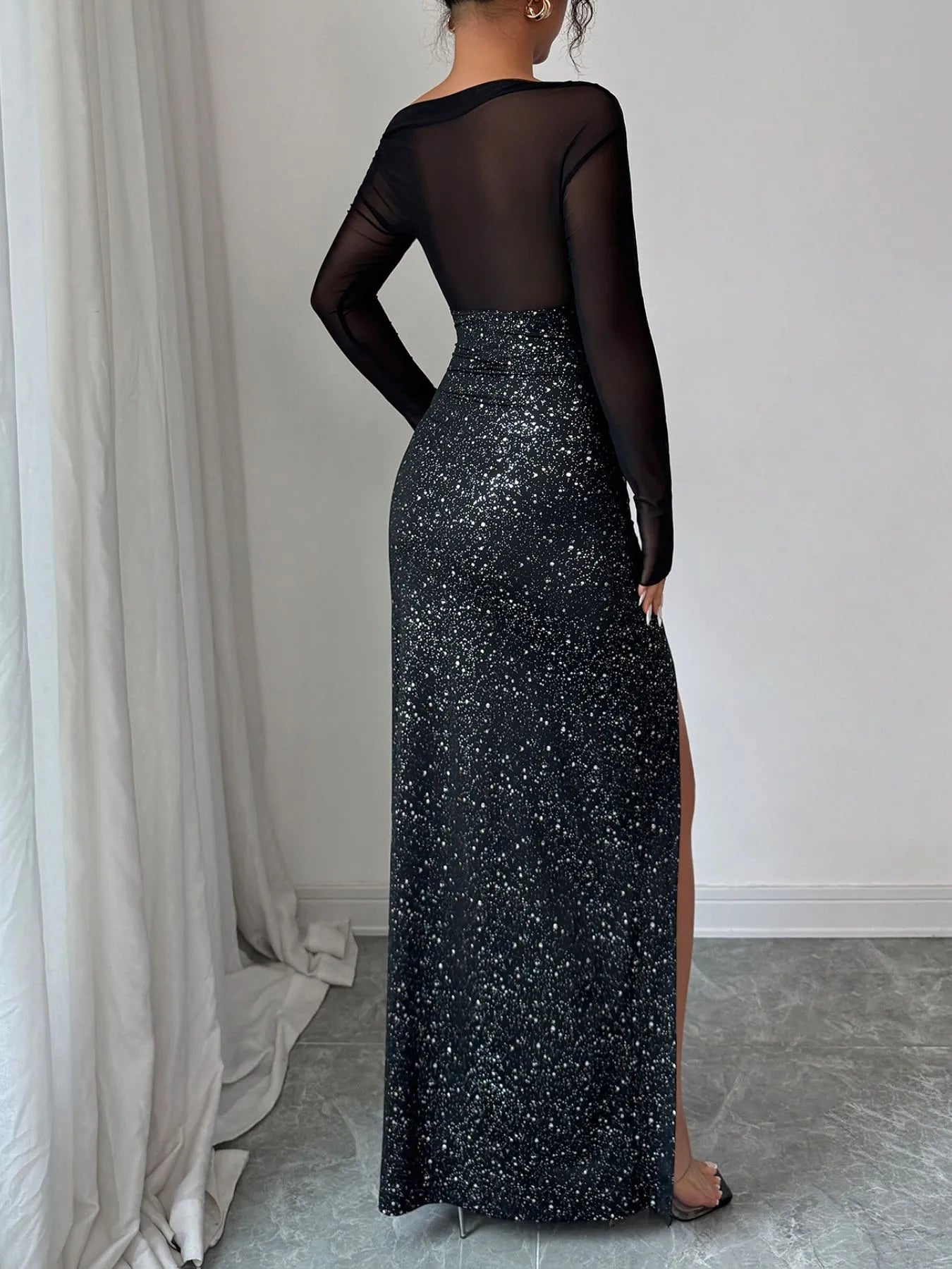 black sequin one shoulder maxi dress back view with sheer long sleeve and thigh slit