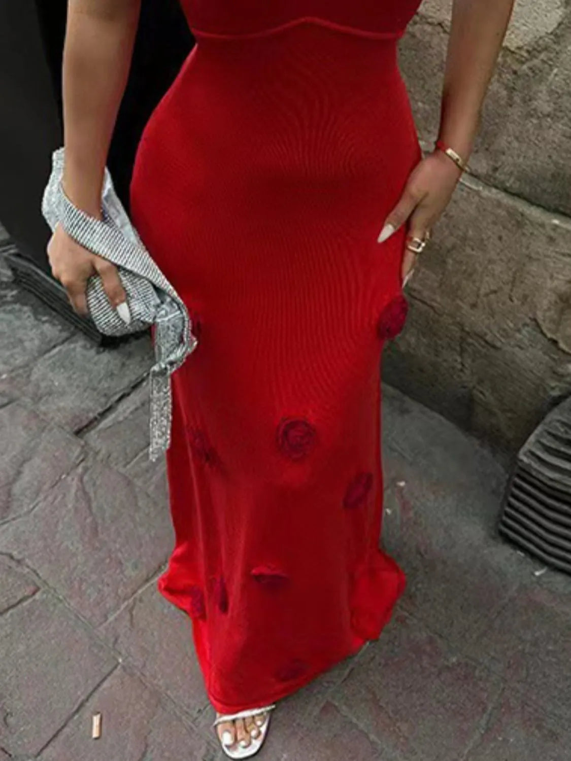 red knit cami dress with rose appliques and ribbed texture holding silver clutch and flower maxi sweater cami dress