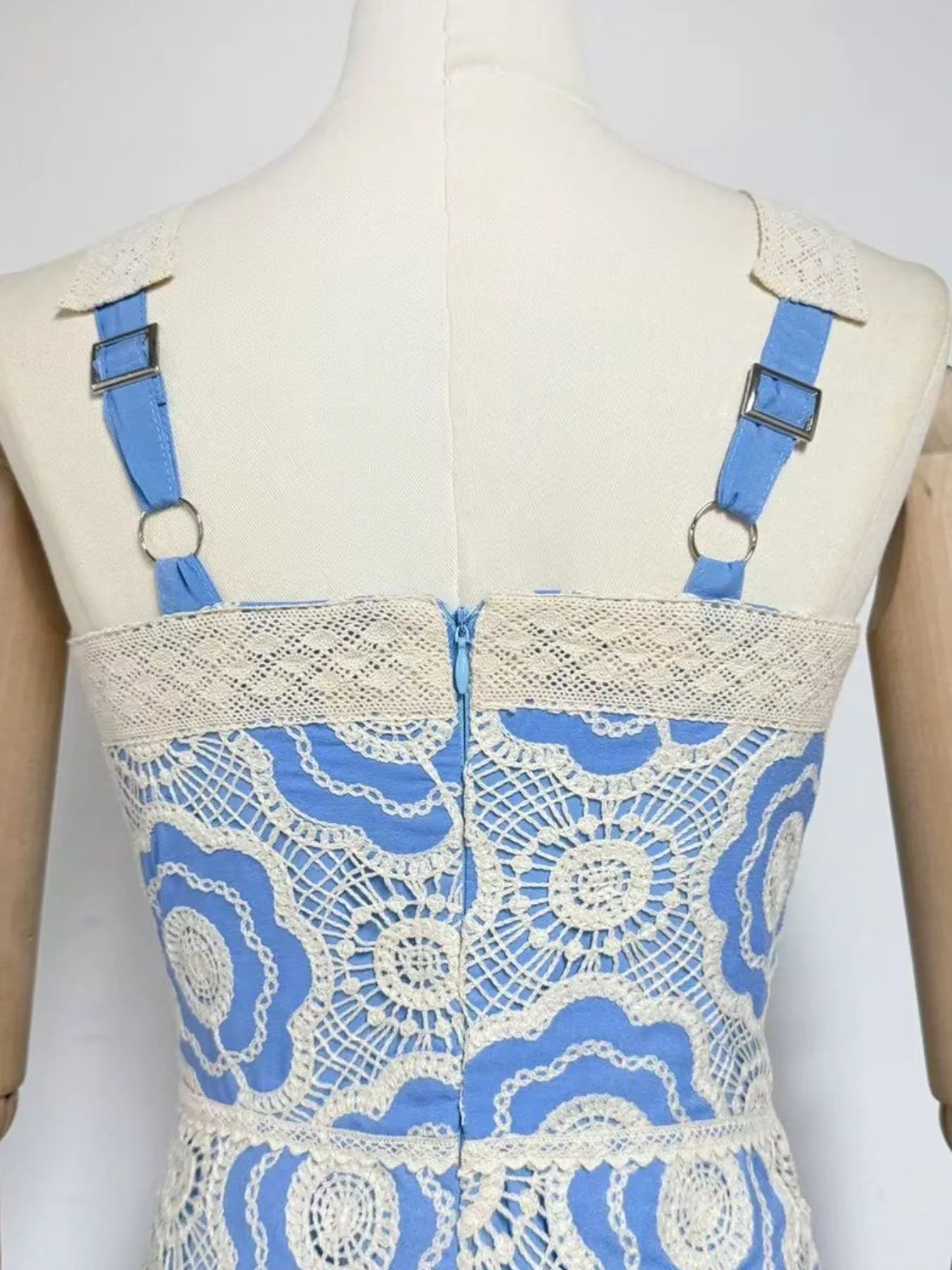 lace tiered midi dress back view on mannequin with cream floral lace overlay and adjustable blue straps