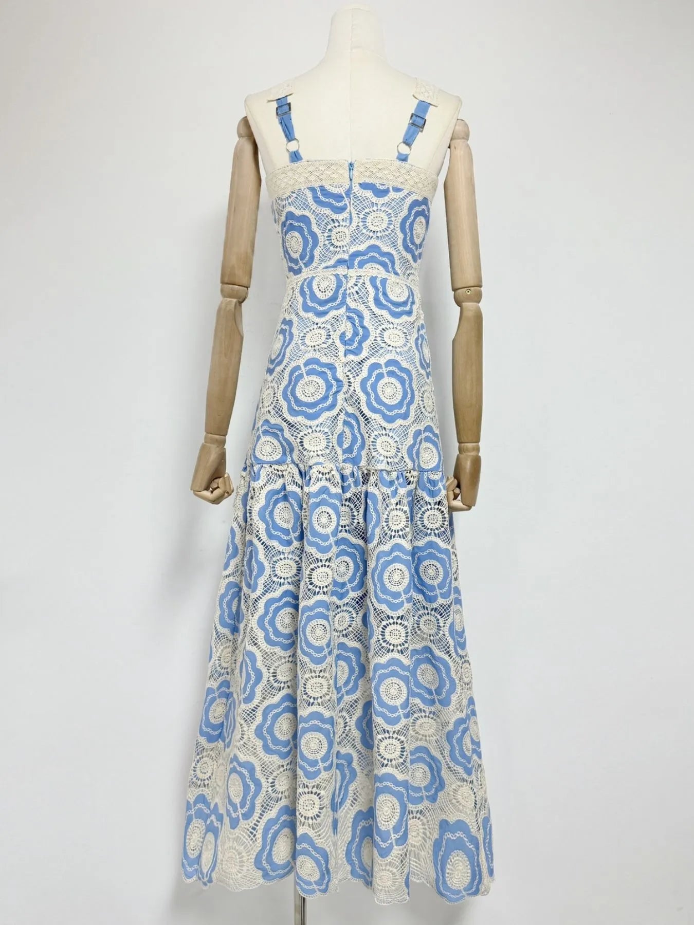 blue and white floral lace tiered midi dress back view with adjustable straps and fitted bodice