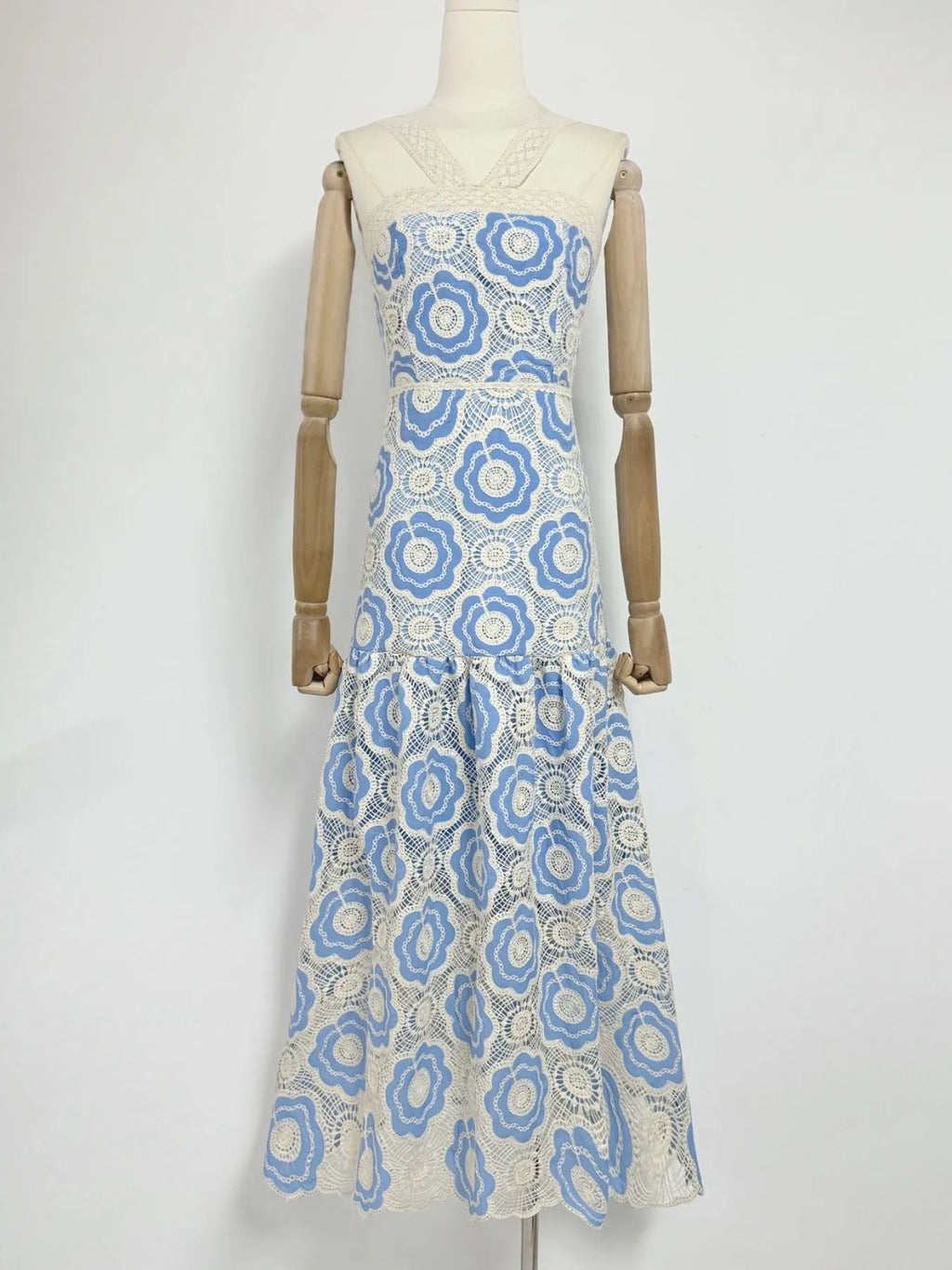 white and blue floral lace tiered midi dress with V neckline fitted bodice and flared skirt