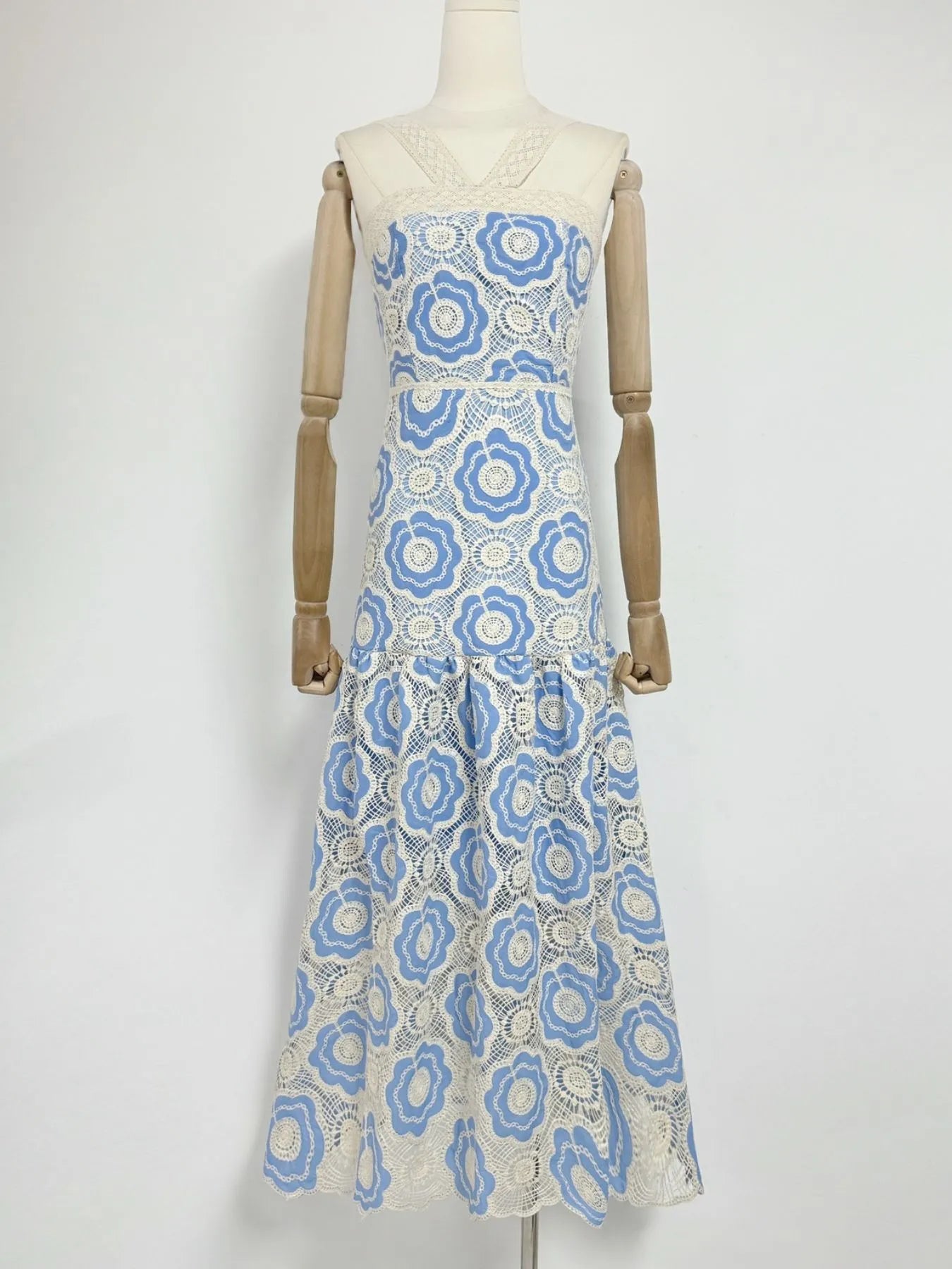 white and blue floral lace tiered midi dress with V neckline fitted bodice and flared skirt