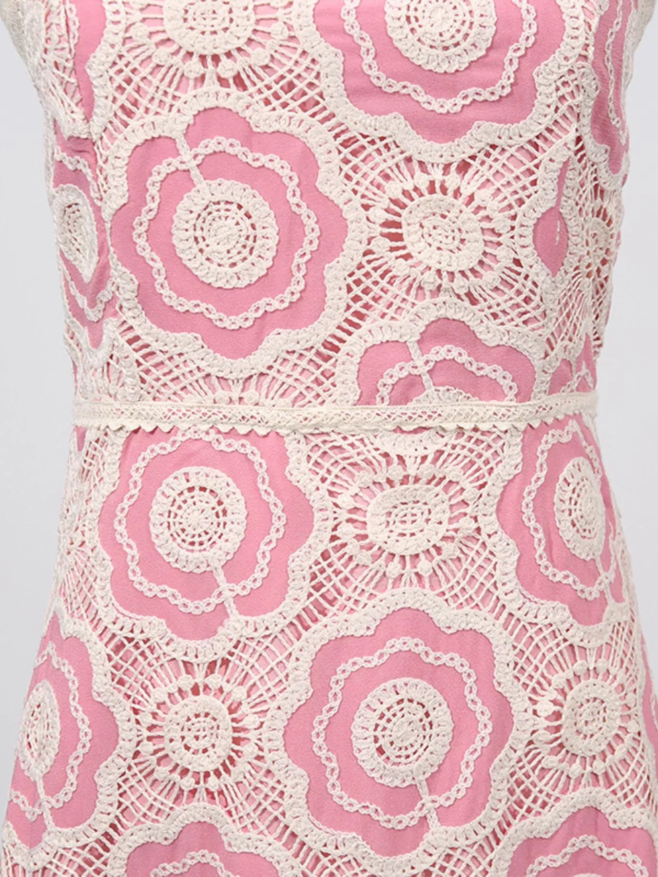 pink dress with cream crochet floral overlay and waist seam showing lace tiered midi dress texture