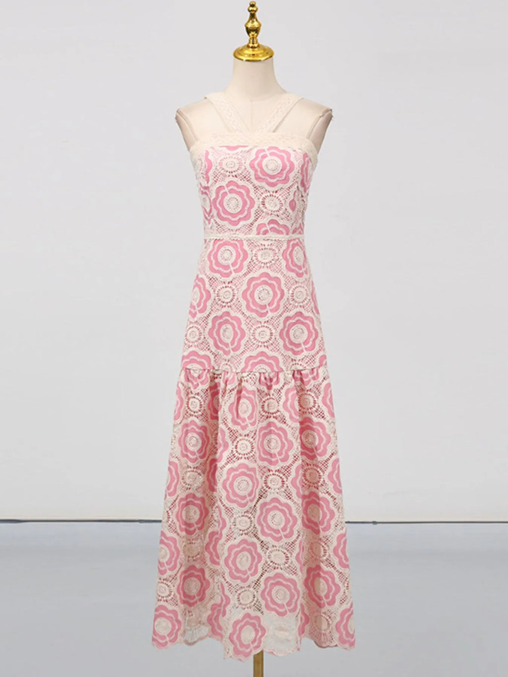 lace tiered midi dress in pink and white floral lace with sleeveless fitted bodice and flared tiers