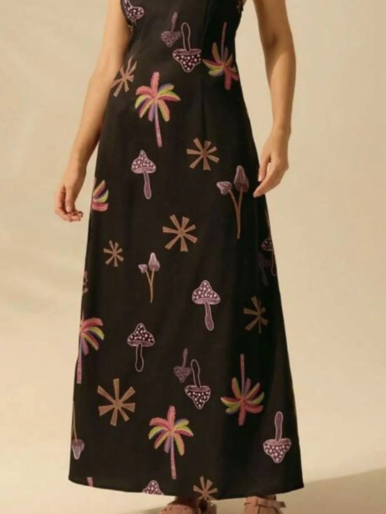 printed sleeveless maxi dress in black with pink and beige mushroom and palm prints ankle length