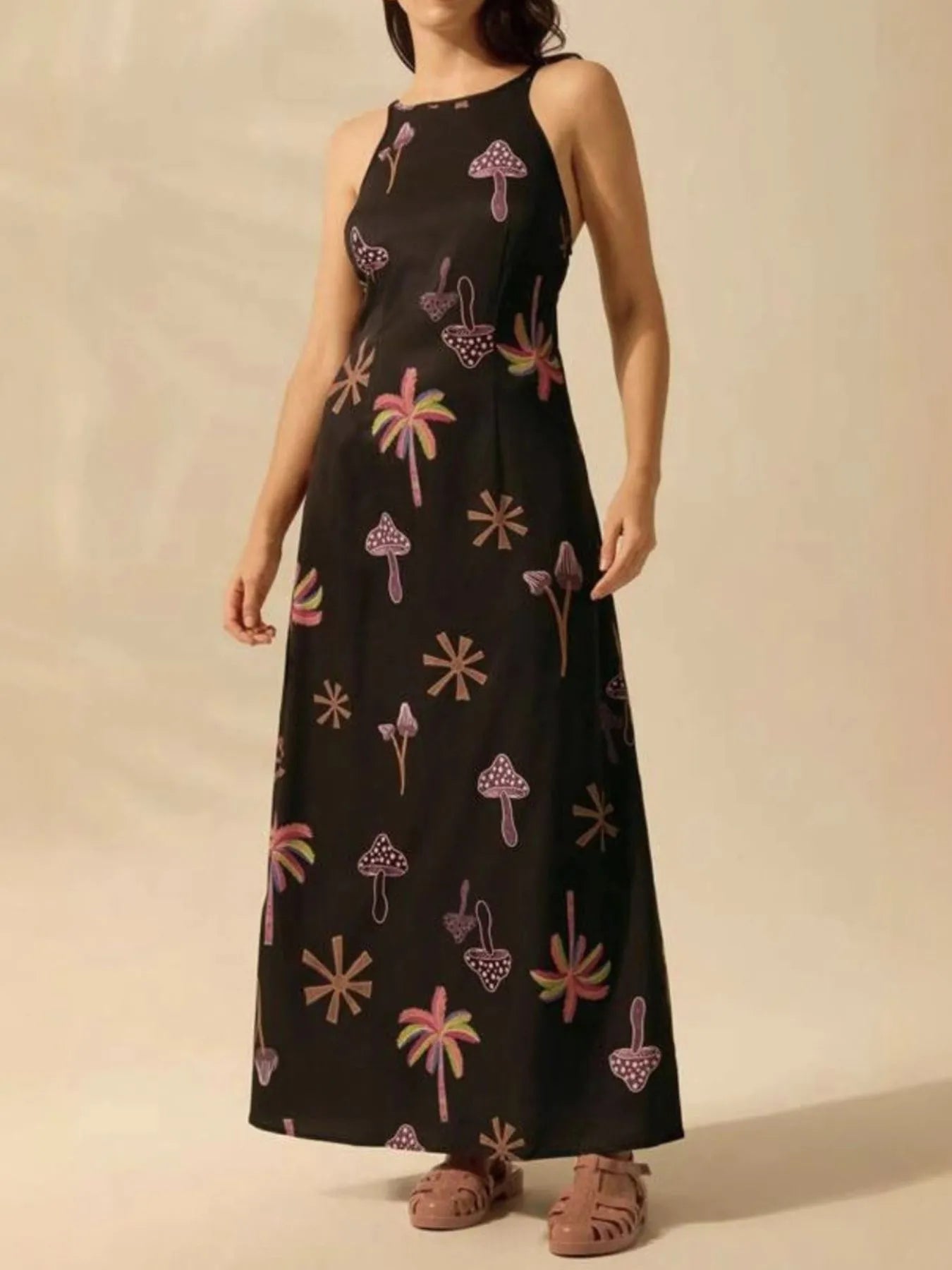 black printed sleeveless maxi dress with pink mushroom and palm motifs high halter neckline and relaxed fit