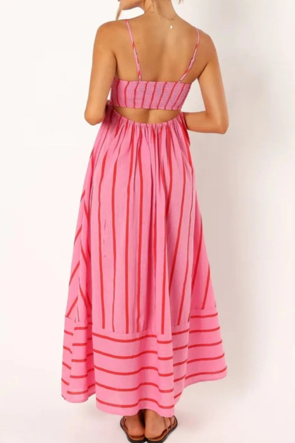 Back view of pink and red striped square neck cami dress with smocked bodice open back and flowy maxi skirt