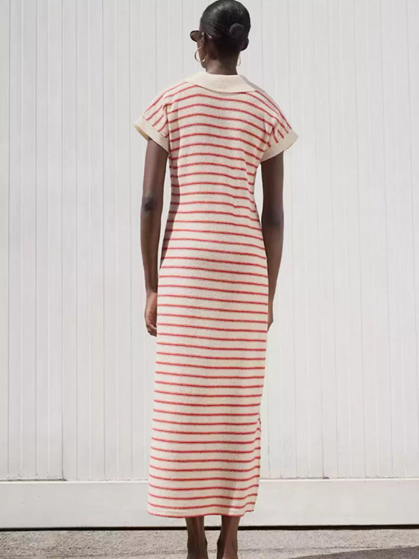 Back view of woman wearing striped maxi dress for women cream and red knit with short sleeves