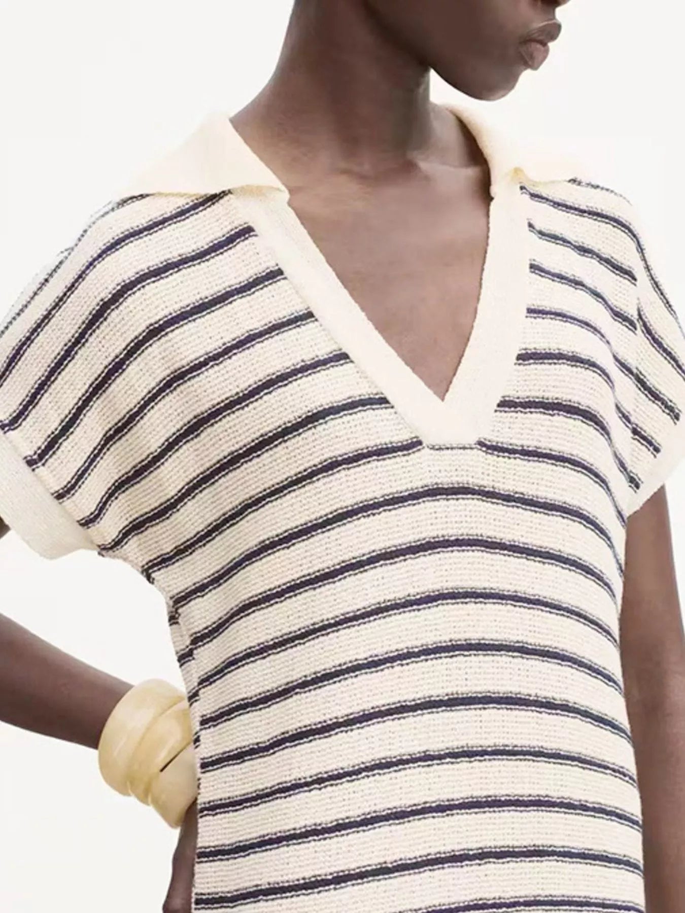 Model wearing cream knit collared v neck striped maxi dress for women with navy stripes
